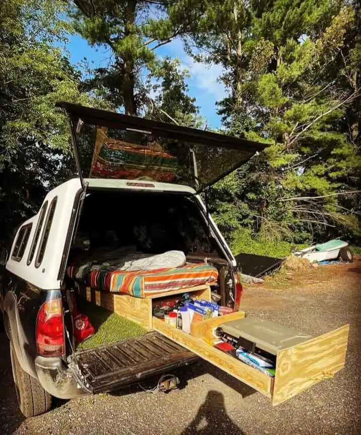 wooden sleeping platform for truck canopy camping in a truck, maximizing storage space on a campsite in woods