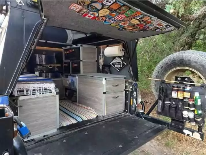 Truck canopy camper with organized gear and accessories